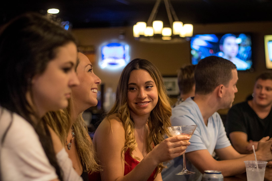Group of People Enjoying Drinks at a Bar