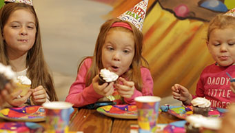 Kids Eating Cupcakes at a Birthday Party