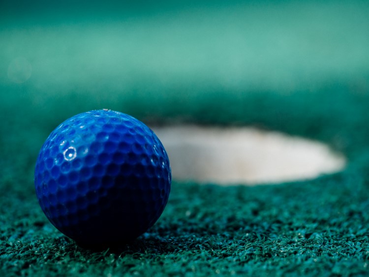 mini golf ball going into hole